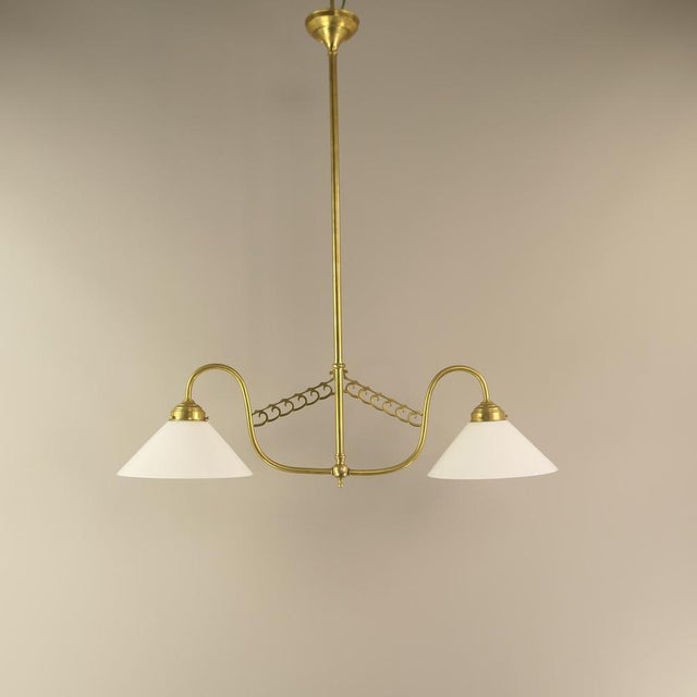 Chandelier made of massive brass with opal glass shade. The light provides a pleasant, glare-free light. Polished surface....