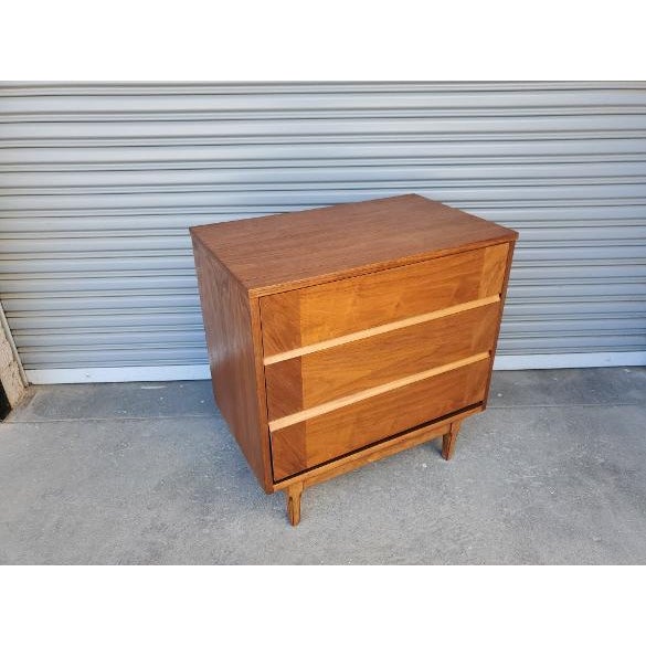 Vintage mid-century walnut low boy. The low boy is made out of walnut, with dovetail drawers. The piece is most likely...
