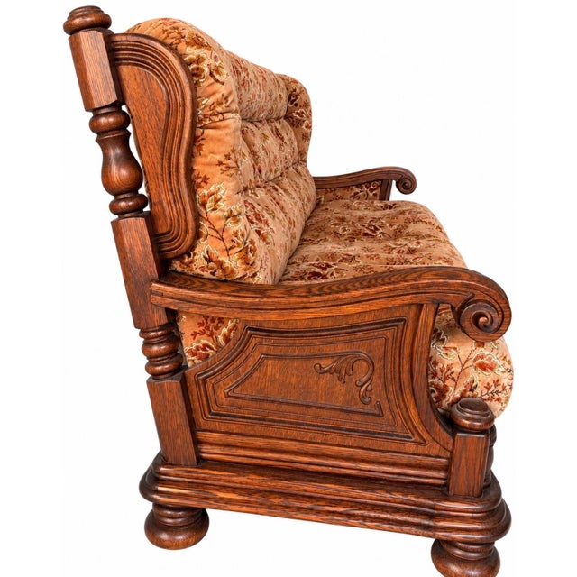 - Wood: Solid oak construction - Design: Ornately carved wooden arms with decorative scrollwork - Design: Turned wooden...