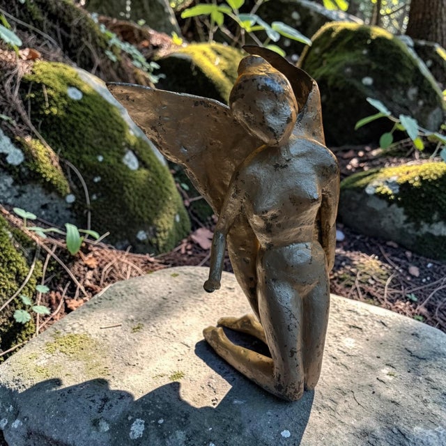 Striking signed and dated 1997 bronze sculpture depicting a kneeling female angel with dramatic outstretched wings. The...