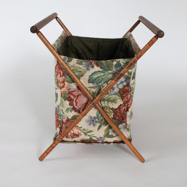 Vintage wood x-frame cloth sewing bag/basket with flowering motif. Folds flat for storage. No makers mark. One tear on the...