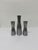 Set of three patinated polished steel candle holders by Erika Pekkari for Ikea circa 1990s. Measurements: Large - W2” D2”...