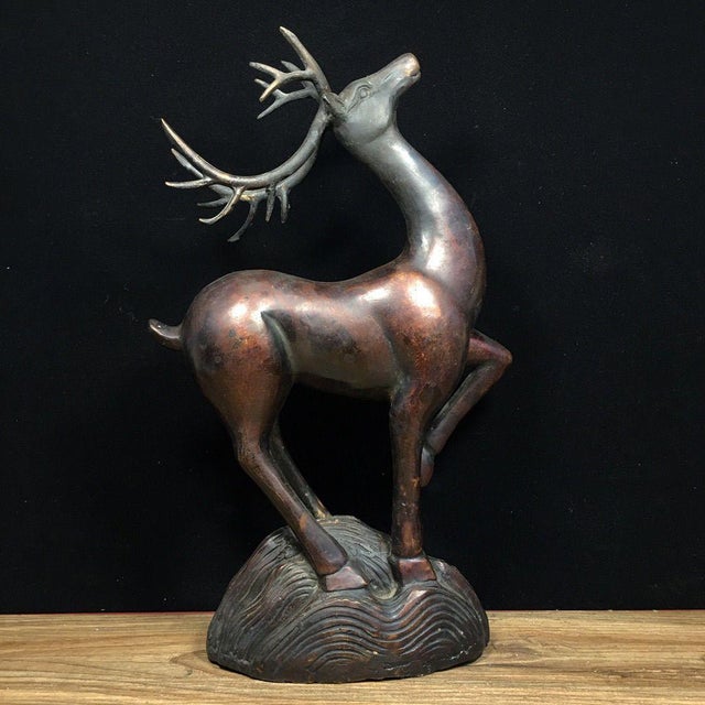 A handsome pair of Chinese solid-copper deer figurines, each posed with graceful outstretched antlers upon a textured...