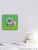 This mixed media artwork features a vibrant, oversized donut adorned with colorful sprinkles, set against a bright green...