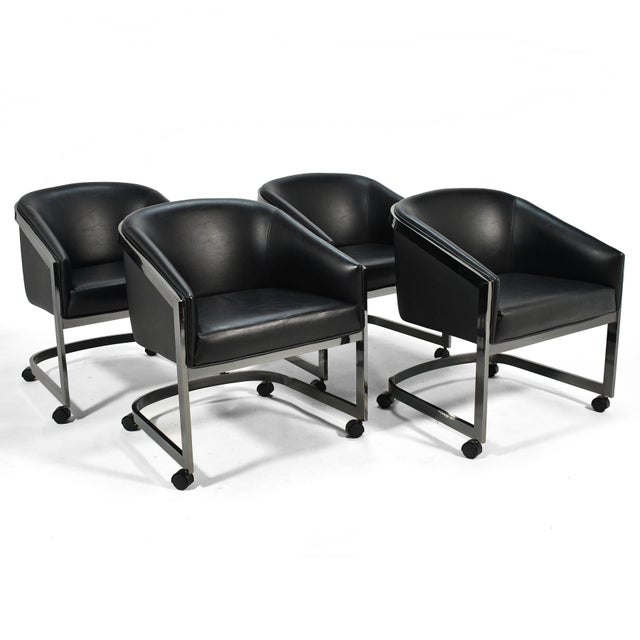 This handsome set of four D.I.A. chairs feature a barrel back, an external frame finished in "midnight chrome" that...