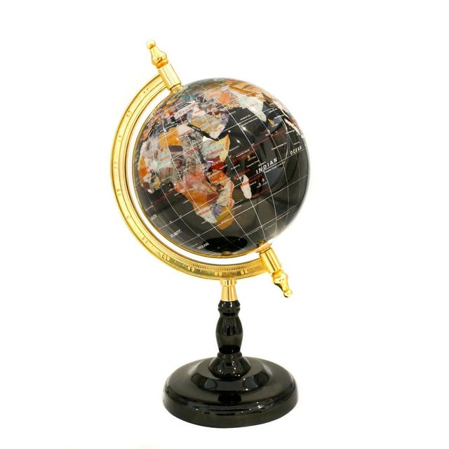Terrestrial globe, realized in the late 20th century in plastic to imitate hard stones, with the golden metal axis and...