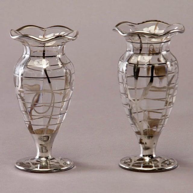 Circa 1940s pair of clear glass vases with fluted top and silver overlay. Unknown maker.