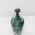 Bottle-shaped vase, made of thrown stoneware, covered with a cloudy glaze in celadon tones, deep greens punctuated by dark...