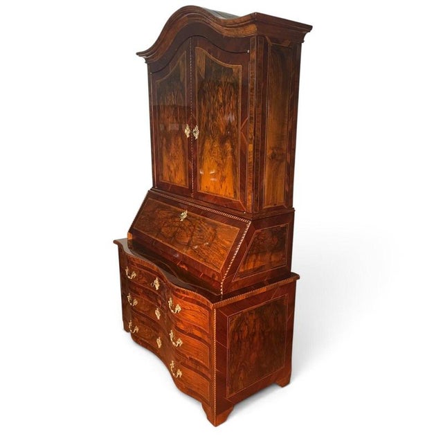 An impressive 18th-century Baroque bureau cabinet, distinguished by its architectural proportions, serpentine form, and...