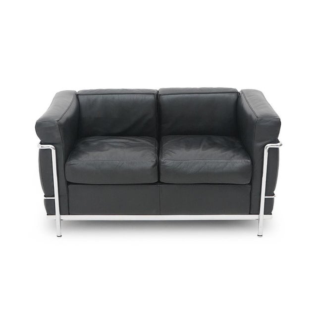 Iconic LC2 two-seater sofa, designed by Le Corbusier, Pierre Jeanneret and Charlotte Perriand and produced by Cassina in...