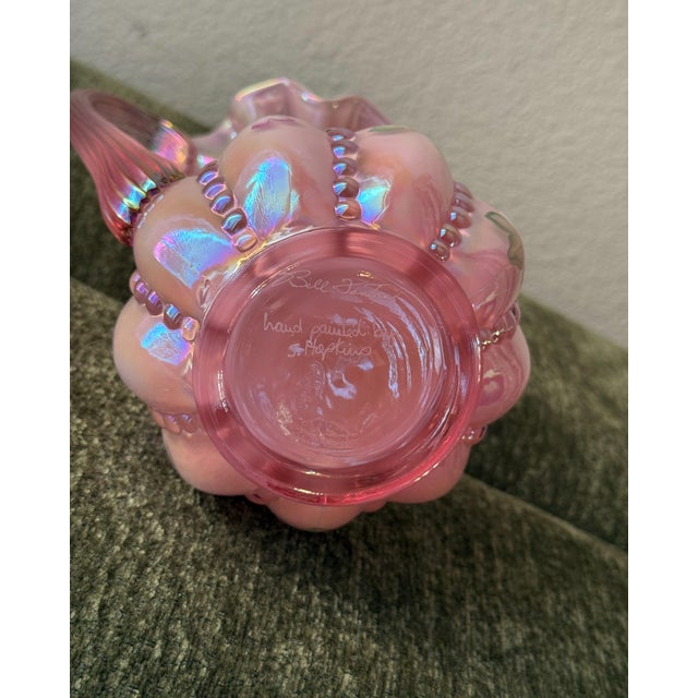 A collectible Fenton Art Glass beaded melon pitcher crafted in luminous pink iridescent glass. The sculptural form...