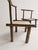 An exceptional pair of antique primitive low chairs featuring extensive hand-carving. Originating from the early 20th...