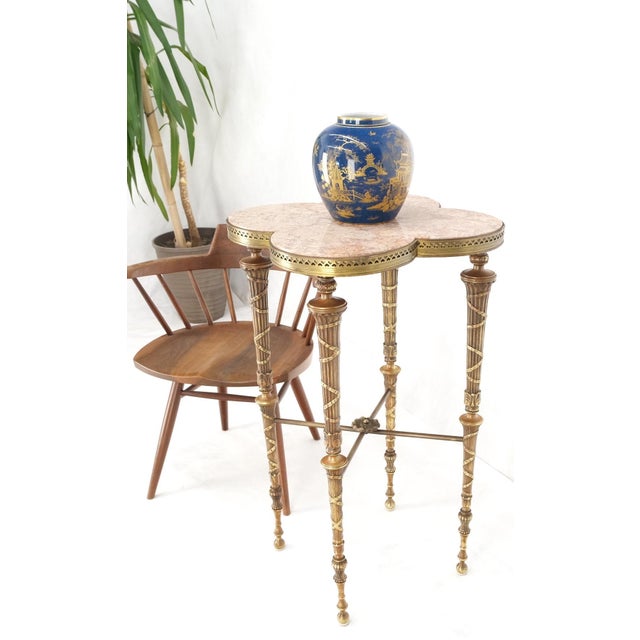 Exception clover shape pink marble top fluted brass legs tall pedestal stand.