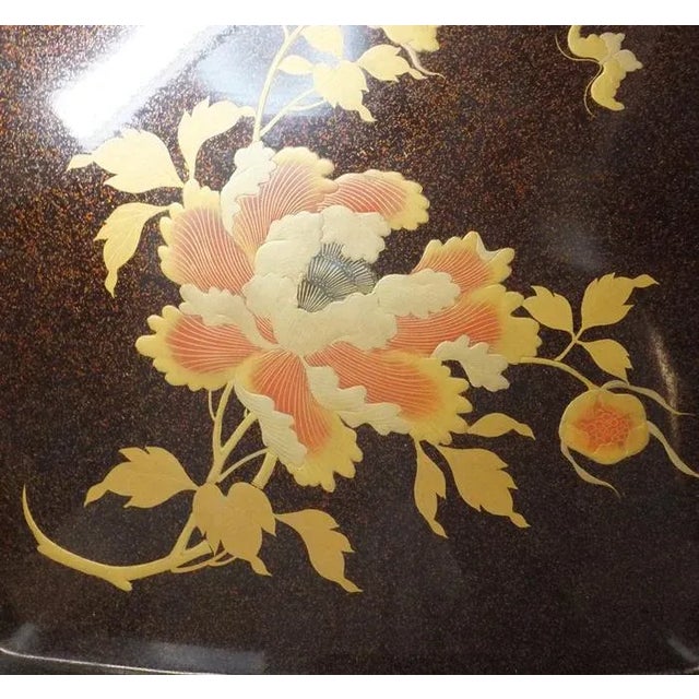 A beautifully lacquered tray from the Edo Period. A rich black base is adorned with nashij-i and maki-e, depicting a...