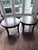 A beautifully matched pair of dark mahogany circular side tables in the Chippendale tradition. Each features a graceful...