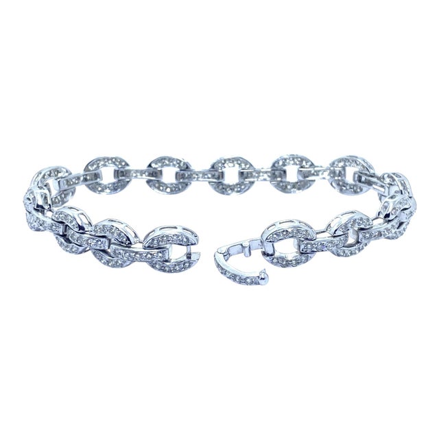 Vintage 18K white gold bracelet composed of a series of alternating oval and bar links encrusted with diamonds creating a...