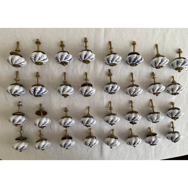 Hand painted vintage blue and white pulls for cabinets and drawers. Note that six of them do not have the inner brass...