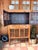 Beautiful vintage Chinese chicken coop cabinet with intricate hand-worked lattice doors, warm natural wood tones, and aged...