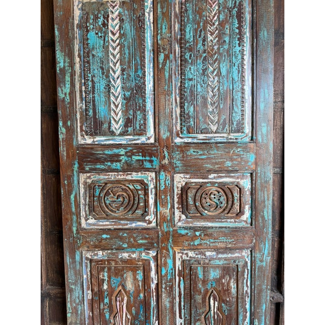 Bring timeless character to your space with this antique hand-carved barn door, featuring a beautifully weathered blue...