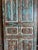 Bring timeless character to your space with this antique hand-carved barn door, featuring a beautifully weathered blue...