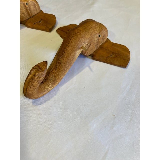 This set of 2 hand-carved wooden elephant wall plaques showcases beautiful craftsmanship and rich natural wood tones. Each...
