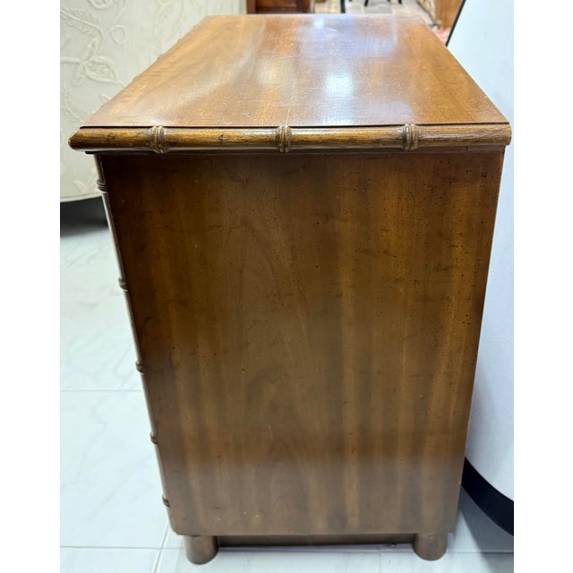 Vintage Drexel faux bamboo nightstand with one drawer and lower shelf for your books and magazines.