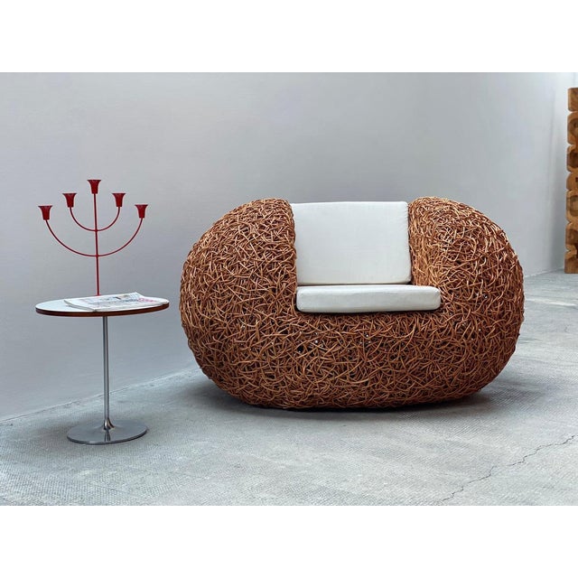 Absolutely fantastic vintage rattan lounge chair in a sculptural egg shape, reminiscent of Udom Udomsrianan’s Nest Chair,...
