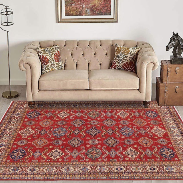 Enhance your home with this exquisite hand-knotted Super Kazak rug, crafted from fine hand-spun wool and dyed with all-...