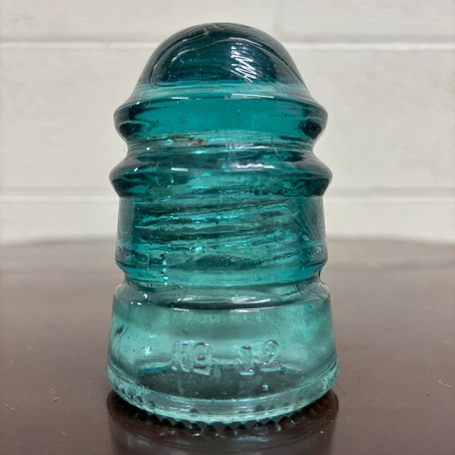 This is a gorgeous antique teal glass Hemingray No 12 insulator embossed “HEMINGRAY 12.”Produced by the Hemingray Glass...