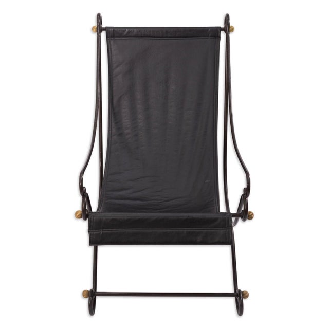 A sling back chair in the Campache style, attributed to designer David Hicks. The frame is crafted from wrought iron with...