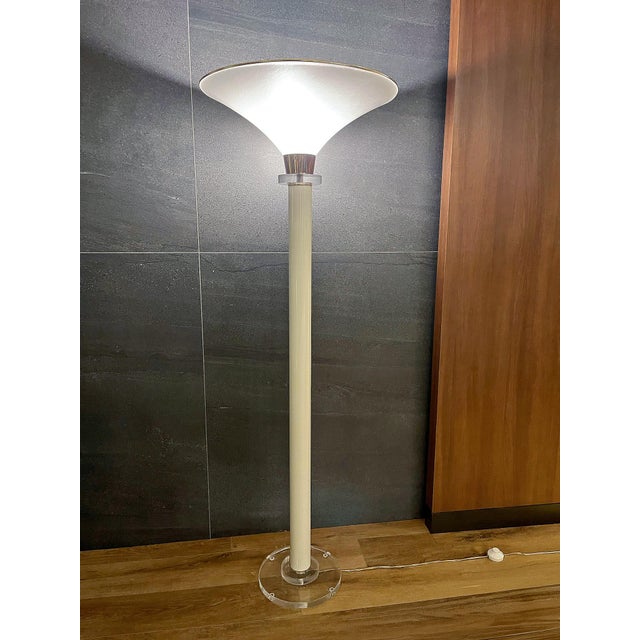A refined vintage torchiere floor lamp with a tall, architectural profile and an elegant combination of clear Lucite,...
