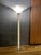 A refined vintage torchiere floor lamp with a tall, architectural profile and an elegant combination of clear Lucite,...