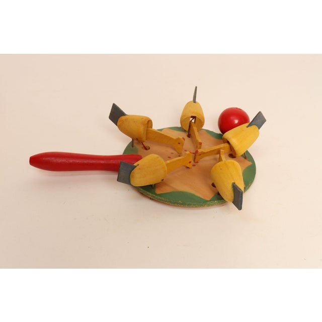 Vintage Folk Art handheld hen pecking game (ca. 1950s, Sweden). Moving the red ball attached to the paddle around in a...