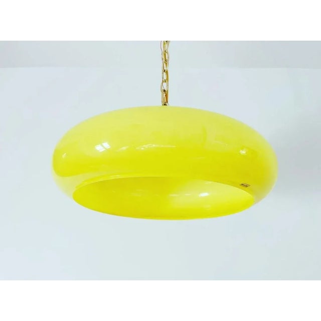 LIMONCELLO! Fabulous and large 1960s/70s Italian modern pendant chandelier featuring a curvy tiered plastic shade in a...