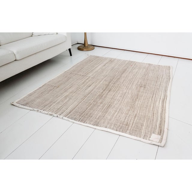 This is a vintage Turkish Oushak rug from the Mid 20th Century. The piece was hand-knotted.