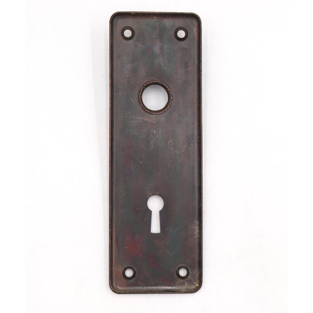 Vintage door back plate made of brass with a japanned finish. The original mounting screws are not available. Good...