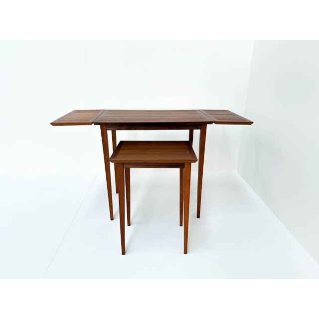 This is a beautiful vintage Scandinavian nesting table set made of warm-toned wood. The design is practical and stylish,...