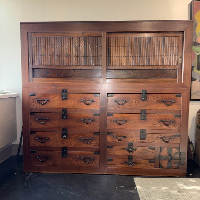 A striking two-part Japanese cabinet (tansu), dating to the early 20th century, most likely Meiji to Taisho period (circa...