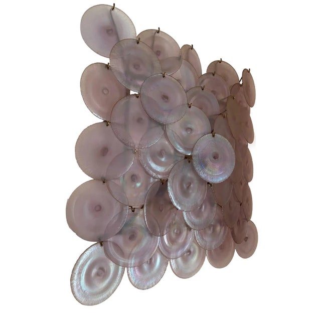 Large disc-shaped applique in irridescent Murano glass designed for Mazzega Murano, Italy 1960. The applique rests on a...