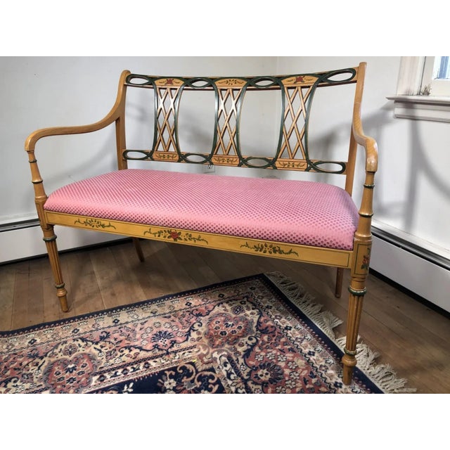 A refinished hand-painted bench or settee with pink upholstery and beautiful painted floral decoration. In Adam style. No...