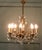 This is a Charming piece in the Rococo style, the 8 branch chandelier is hung with beautiful hand cut crystal lustres it...