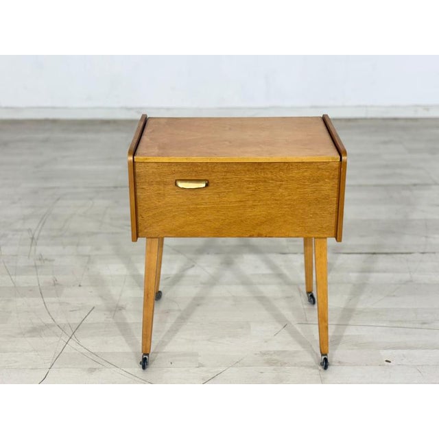 Very cute vintage sewing table in good condition. 1960s German design, very good condition, oak, brass handle, casters....