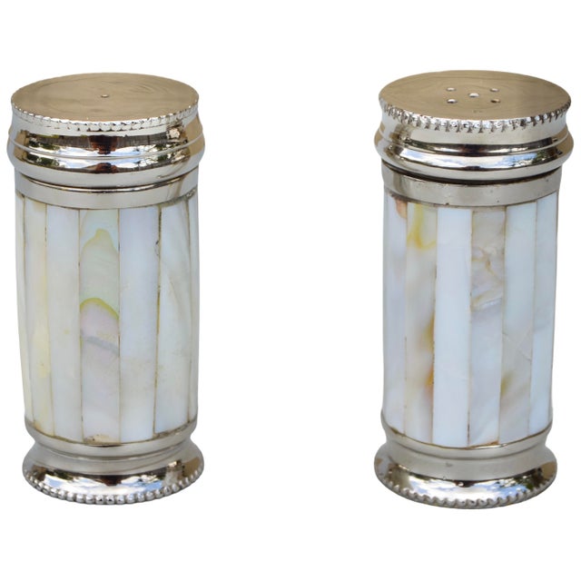 Spectacular playful pair of midcentury very heavy salt and pepper shakers. Elegantly handcrafted of solid silver-nickel in...