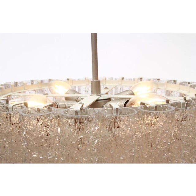 Classic 1960s chandelier by Doria Leuchten Germany. White metal frame. For four E14 bulbs, with one E27 bulb in the...