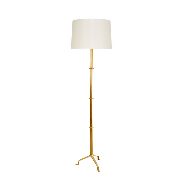 Sitting solidly on three beautifully gold leafed legs, the modern Alvaro penny-foot floor lamp stands tall in any room....