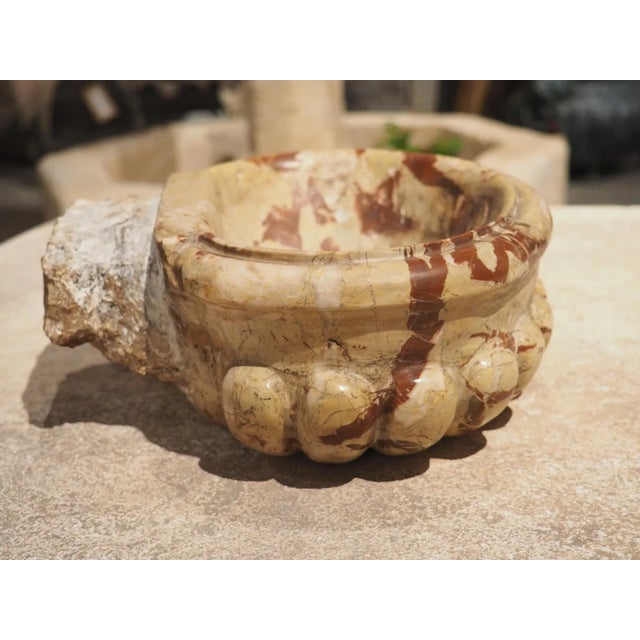 Hand-carved in Italy during the 1900’s, this small marble lobed basin would make a great vide-poche. A vide-poche...