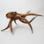 A striking monumental hand-carved octopus sculpture, crafted from a single solid piece of wood, likely suar wood from...