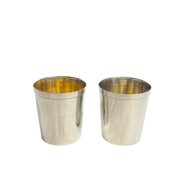 Charming pair of English silver plate drinking tumblers. Each marked Made in England in the base. The interior of each has...