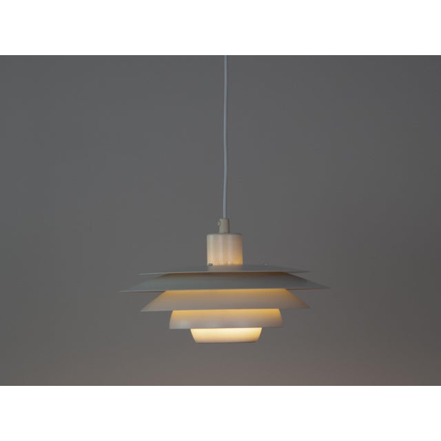 This lamp was designed by Danish designer Kurt Wiborg and manufactured by Jeka. The lamp's form is based on the principle...