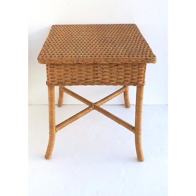A wicker end table with stretcher 'X' base. A great piece as an end table to a sofa or in-between to chairs. Many uses....